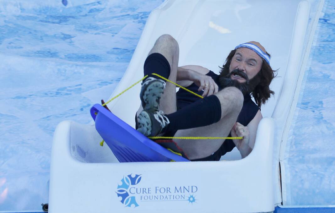 SPORTS NUT: Dave Hughes dressed as Carlton great Bruce Doull as he slides into an ice bath for charity last month. Picture: Darrian Traynor