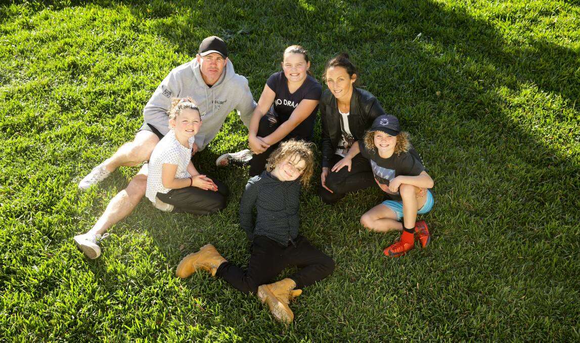 RYAN CLAN: Clockwise from top left, Evie, Andrew, Lily, Olivia, Jett and Bowy at home in Merewether. Picture: Jonathan Carroll