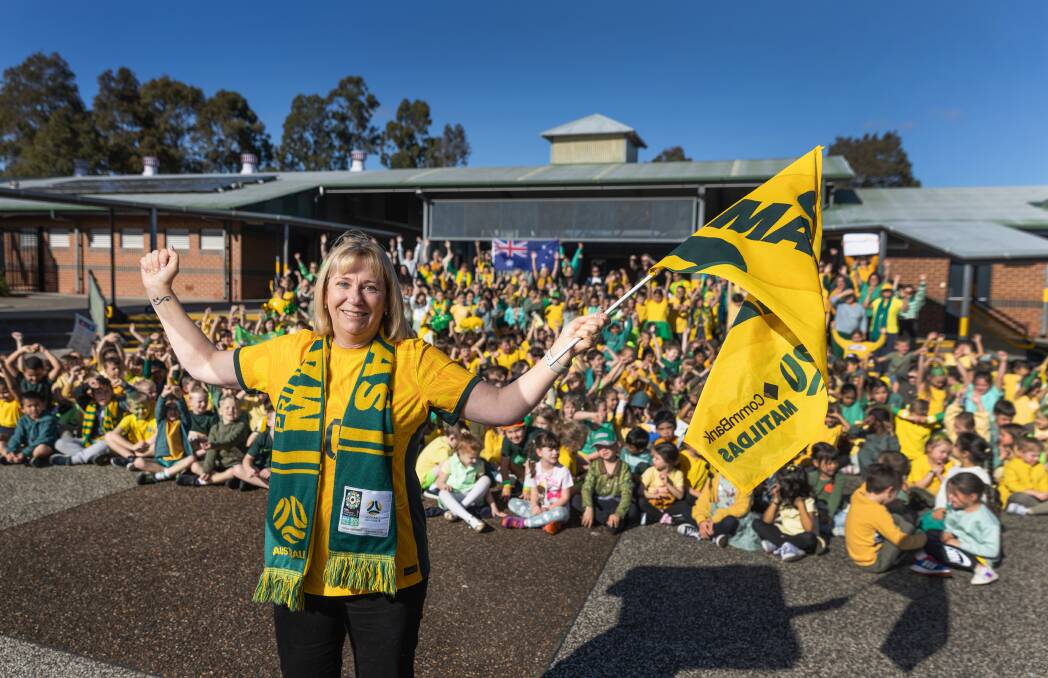 Annette van Egmond, Glendore Public School principal and mother of Matildas star Emily van Egmond, was surrounded by excited students on Tuesday. Picture by Marina Neil 