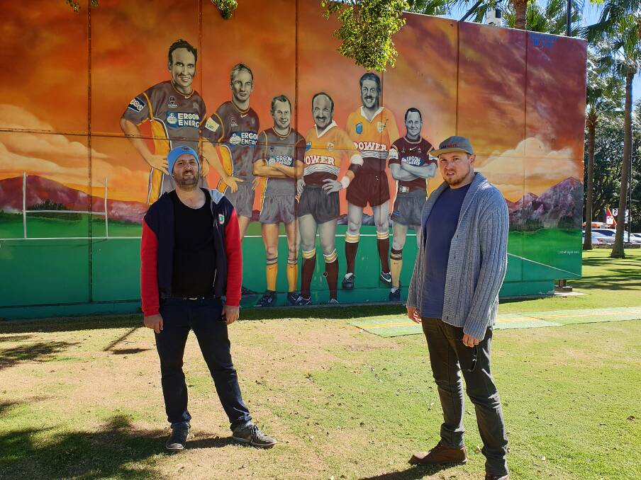 HEADS UP: Nah Mate's Adrian Bubb and Greg Smith in front of the infamous Brisbane Broncos mural outside Suncorp Stadium in 2019.