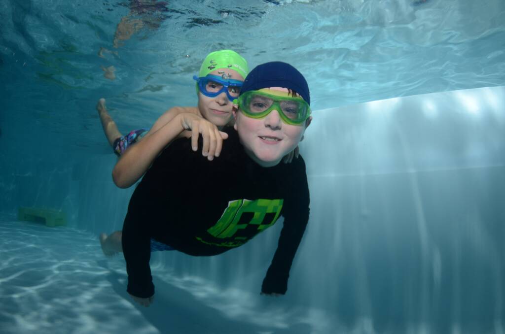 Ethan and Kaiden Rocha have fun under water. Picture Puddle Pics Underwater Photography