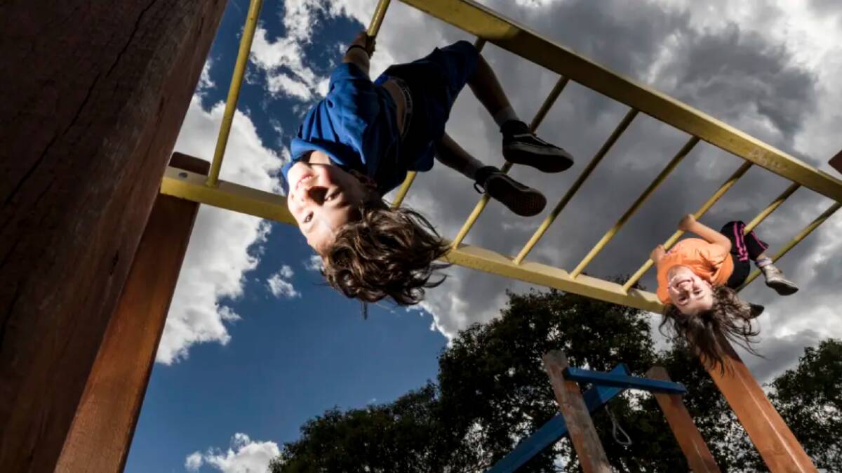 Arlo (8) and Mina (4) love the monkey bars at their local park in Footscray. Photo: Chris Hopkins