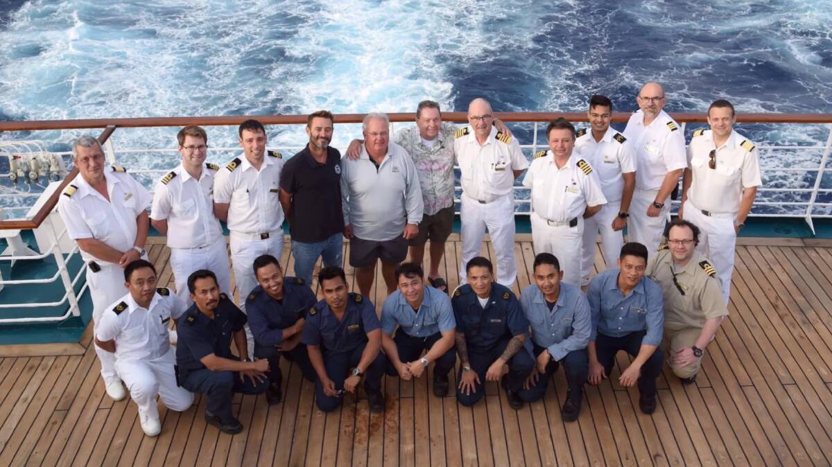 P&O crew with the rescued men. Photo: P&O Cruises