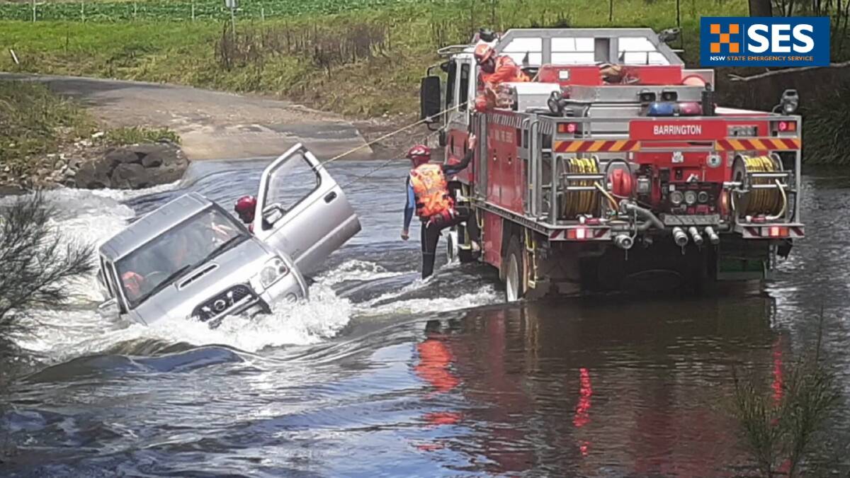 Couple rescued from sideways ute on flooded crossing