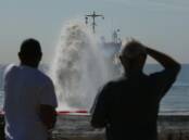 Locals watch the dredge vessel in action. Picture by Simone De Peak