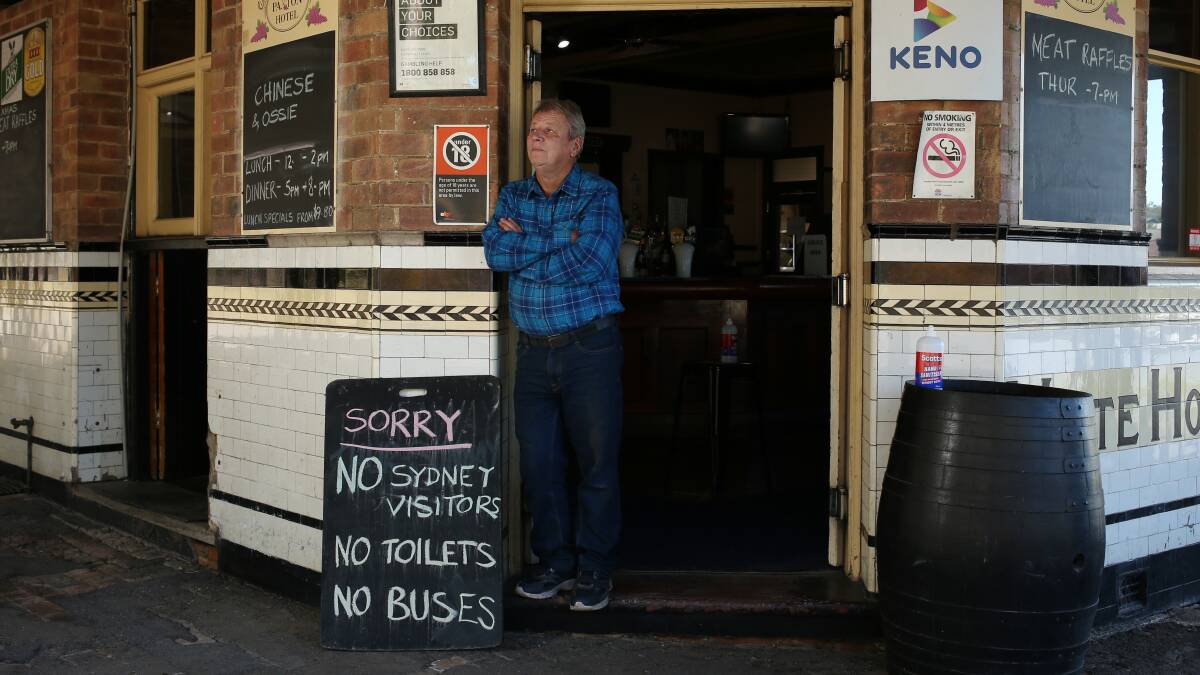 SAFETY: Paxton Hotel licensee Vic Simpson, with his sign outside the pub alerting people they are not accepting people from Sydney at the moment due to recent COVID-19 outbreaks Picture: Simone De Peak