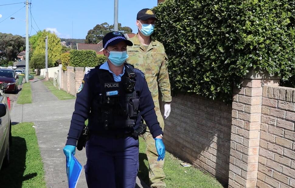 ENFORCEMENT: Police and Australian Defence Force personnel conducting COVID compliance checks in Newcastle on Wednesday. Picture: NSW Police