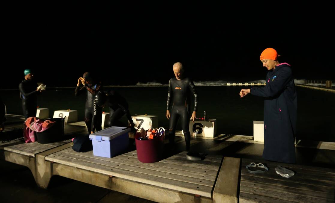 CHILLY: The swimmers brace for the icy cold 5am water.
