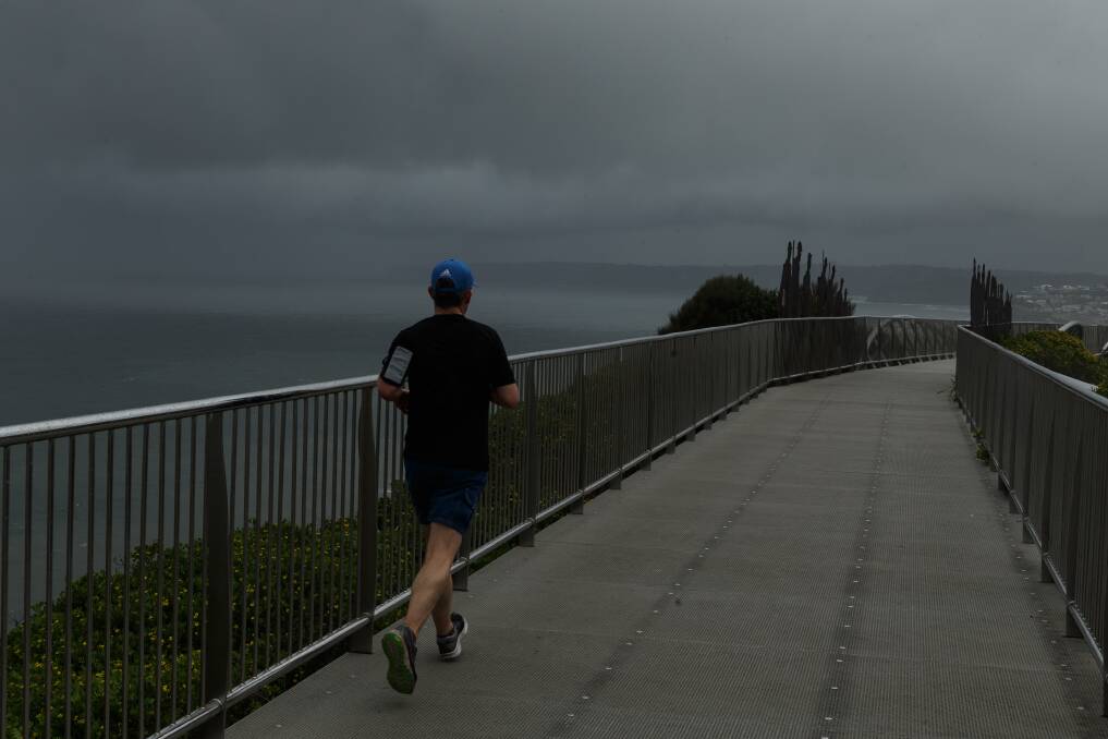 RUN: Storm clouds brew over the Anzac Walk on Thursday. Picture: Max Mason-Hubers