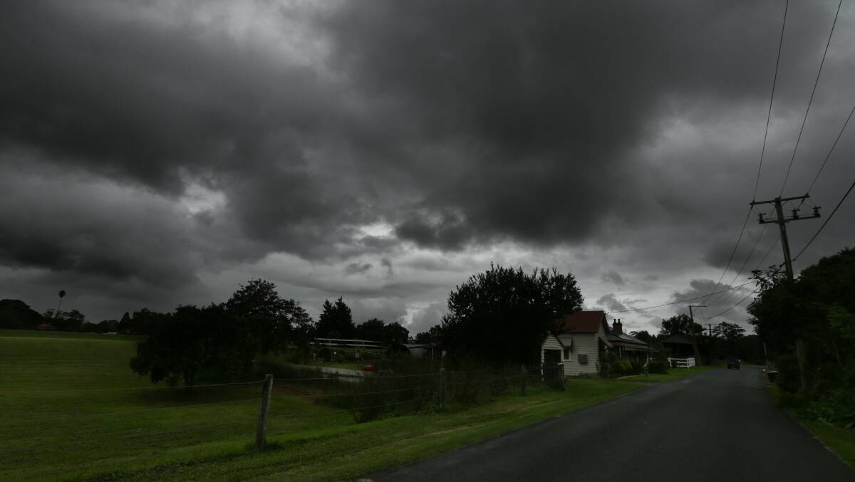 DARK: Storm clouds over a house on Oakhampton Road, Maitland on Thursday. Picture: Jonathan Carroll
