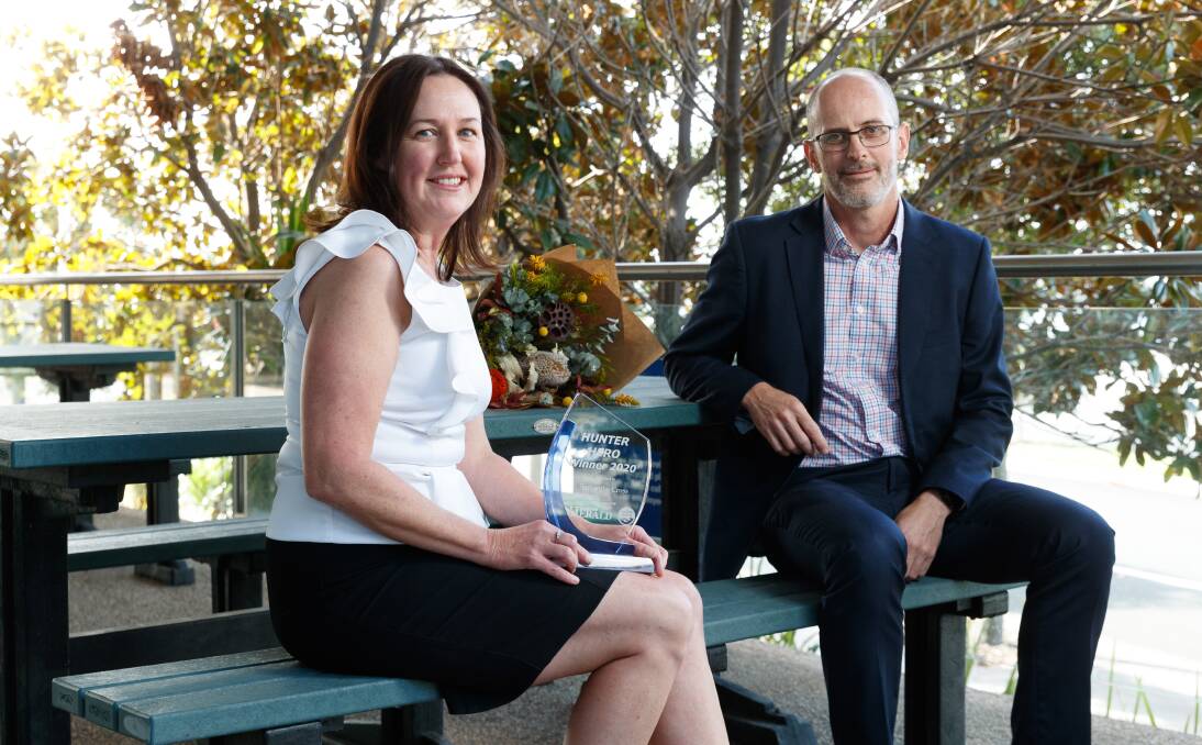 RECOGNITION: Hunter Hero winner Samantha Cross from Plastic Police with Hunter Water managing director Darren Cleary on a bench made from recycled plastic that was sourced through the Plastic Police program. Picture: Max Mason-Hubers