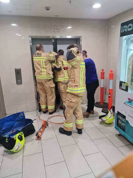 Firefighters working to open the lift at Maitland Riverside Plaza.