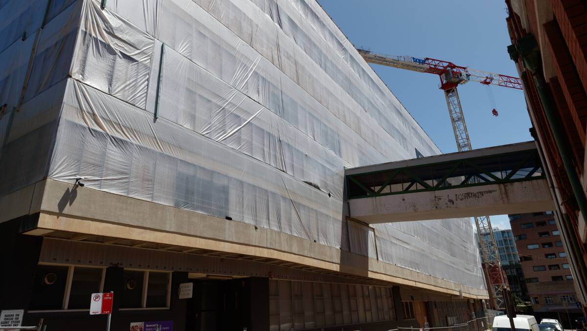 WORKS: The Hunter Street Mall car park is currently wrapped in plastic to assist in the removal of hazardous materials from the site before the structure is demolished. Picture: Max Mason-Hubers