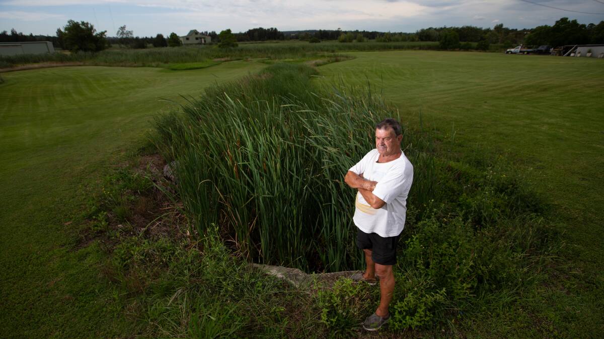 HEARTBROKEN: Rennie Hendler in front of the outlet pipe, which has created a channel that has divided his Maryland property and rendered some of the land useless. Picture: Marina Neil