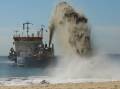 The dredger at work on Stockton Beach in October 2023. Picture by Simone De Peak