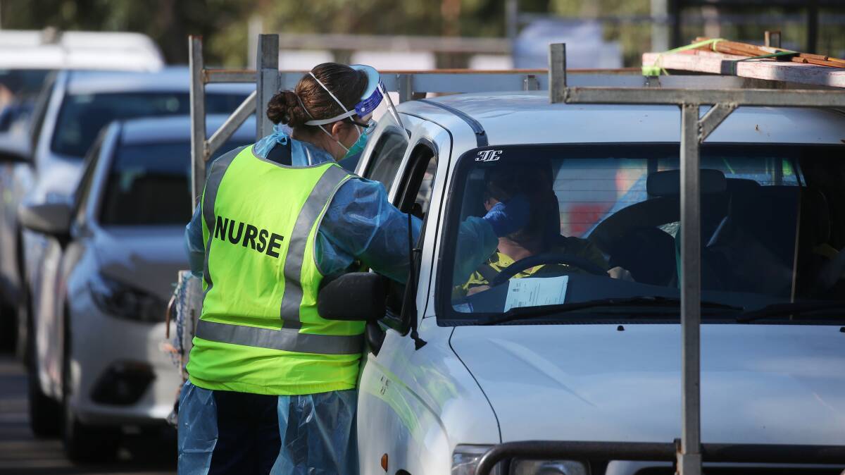 A nurse administers a coronavirus test at the University of Newcastle drive through clinic on Thursday. Picture: Simone De Peak
