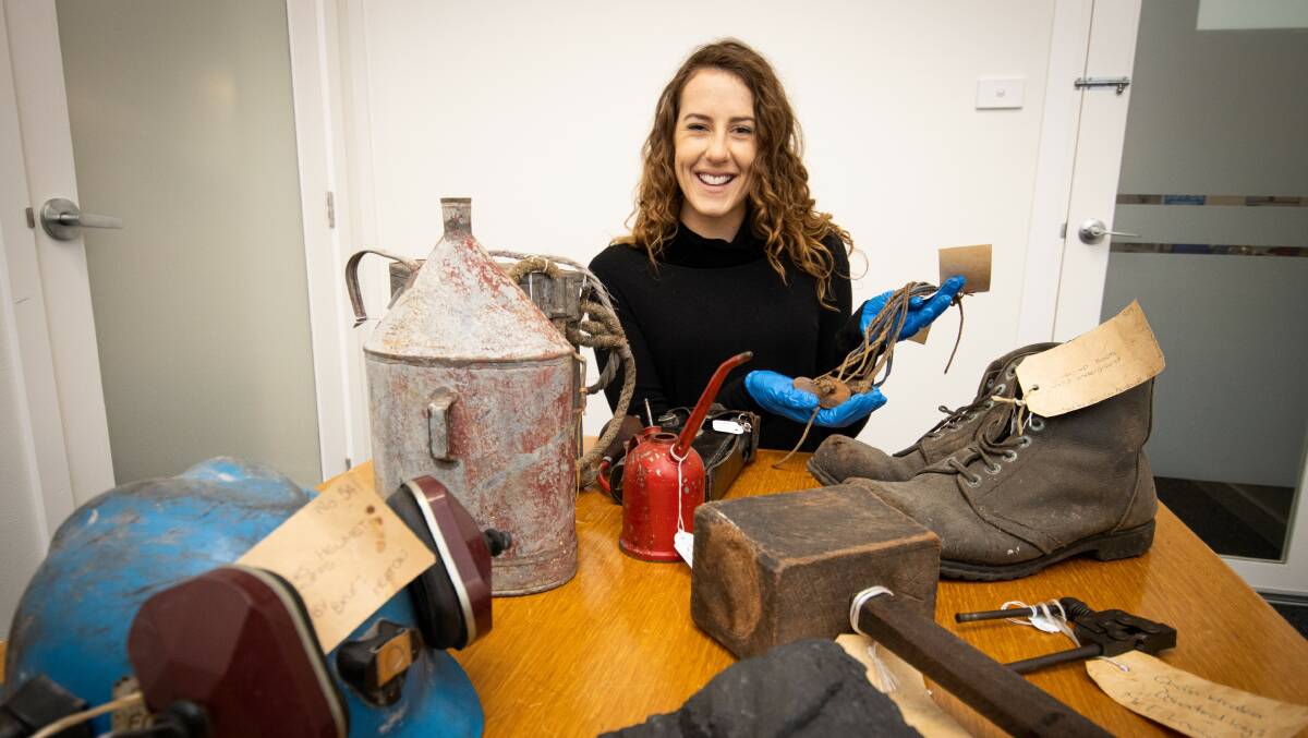 ARTEFACTS: Lake Macquarie Council community museum officer Meg O'Donnell with skip tags once used in the mines, which will be put on display in the new Sugar Valley Library Museum. Pictures: supplied