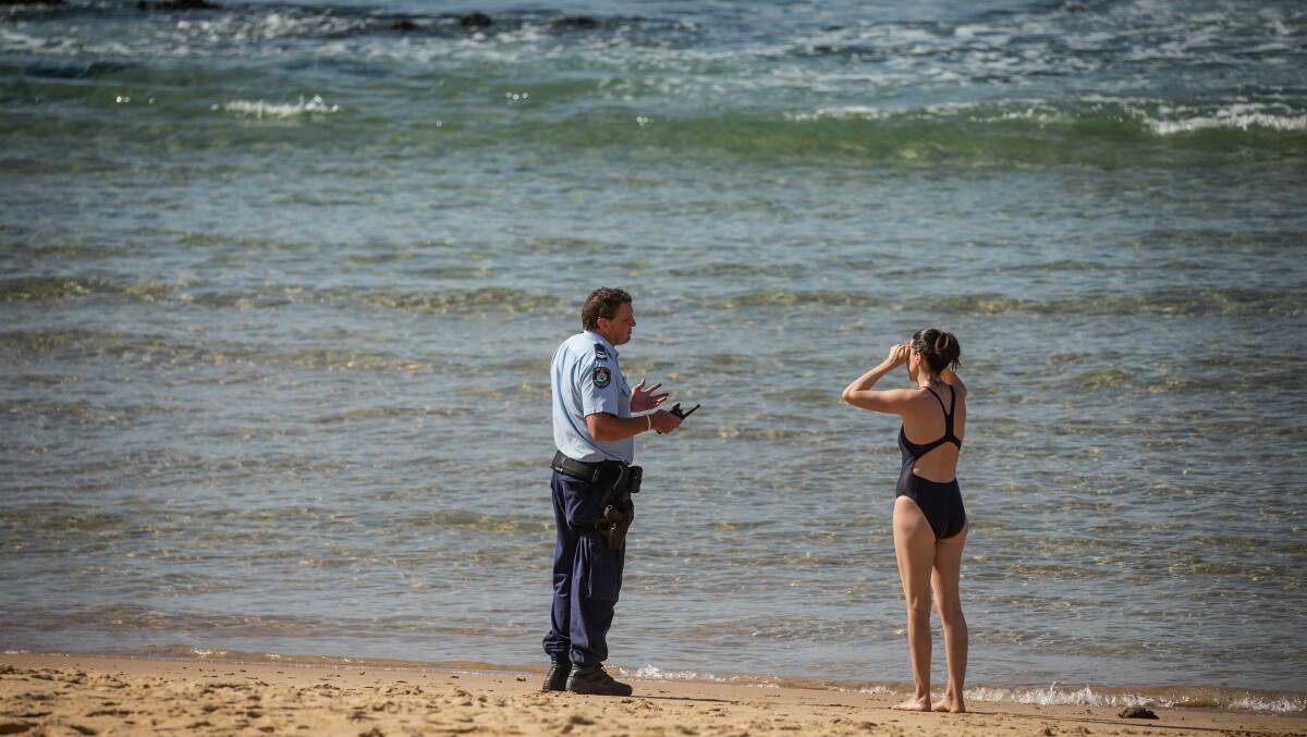 SAFETY: Police officers hit the sand to educate people about coronavirus rules and restrictions after the Hunter's beaches were closed at the end of March. Picture: Marina Neil