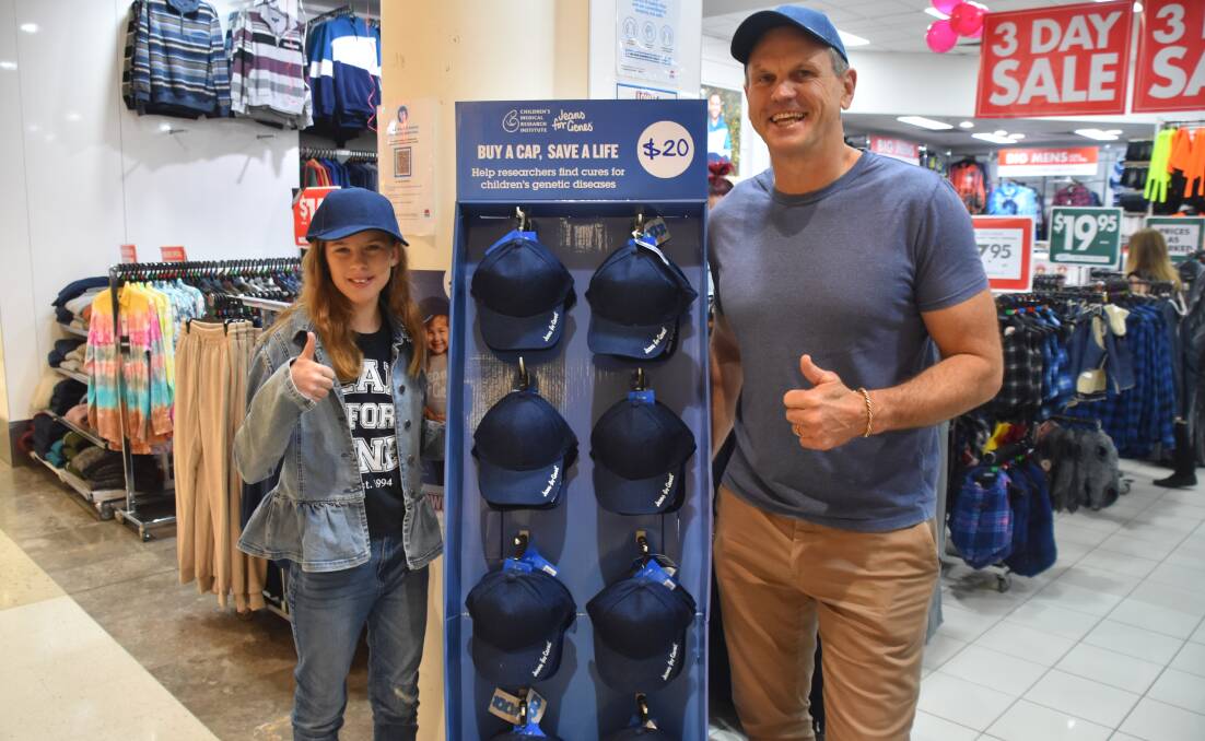 THAT'S GOLD: Mollyjane Rothwell and Paul 'Chief' Harragon promoting the Jeans for Genes denim caps at Lowes Kotara, which will be for sale during August. 