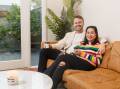 HAPPY HOMEOWNERS: Kyle Griffiths and his partner Tash Ngo in the living room of the home they recently purchased in The Junction. Picture: Max Mason-Hubers 