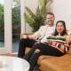 HAPPY HOMEOWNERS: Kyle Griffiths and his partner Tash Ngo in the living room of the home they recently purchased in The Junction. Picture: Max Mason-Hubers 