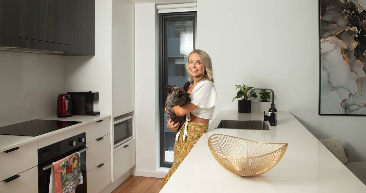 NEW RESIDENT: Abby Saunders, pictured with dog Bodhi, moved into Wickham's Stella apartment complex this year. Picture: Marina Neil