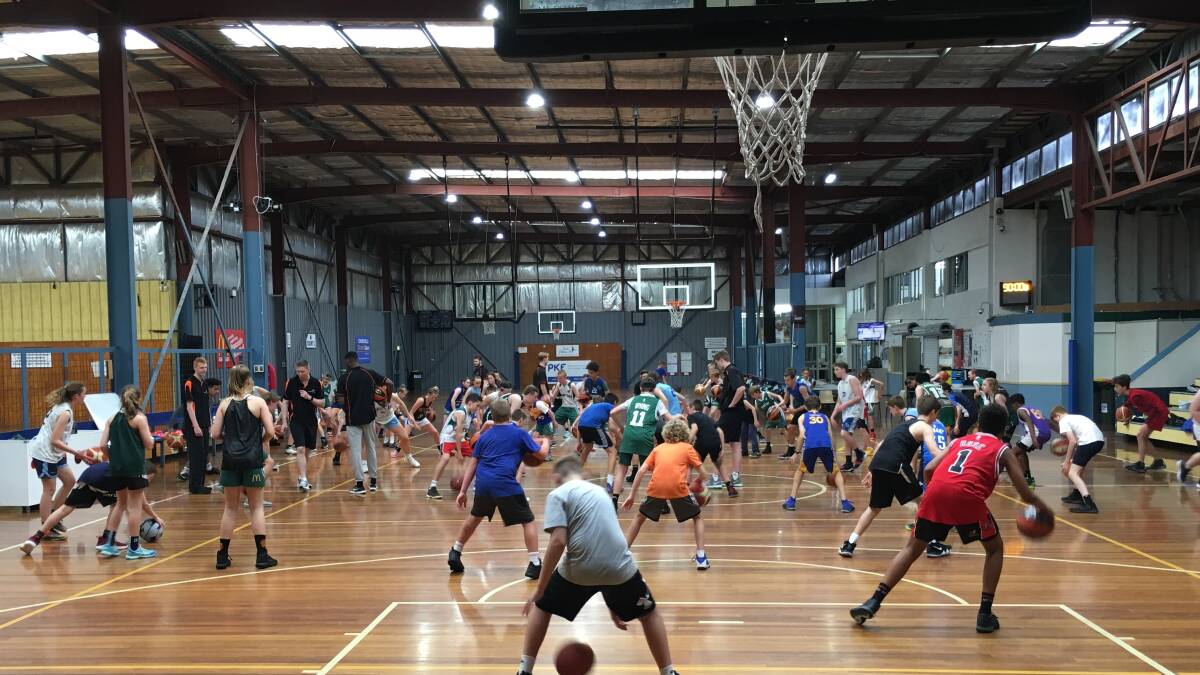 Kids and coaches at a Newcastle Basketball school holiday skills camp.