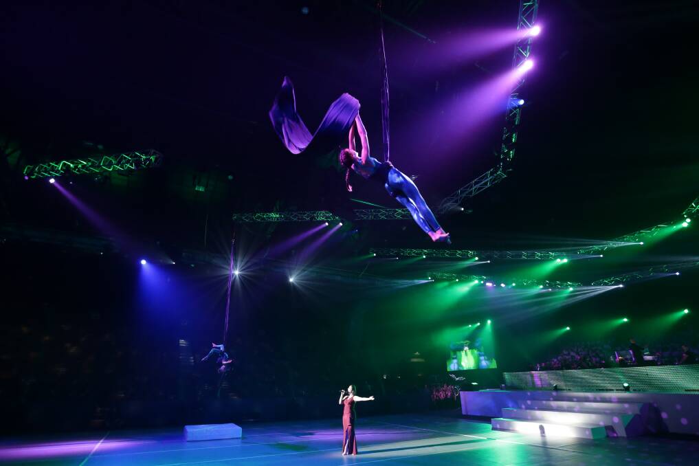 FLYING HIGH: A singer and an acrobat during Defying Gravity. Pictures: Jonathan Carroll