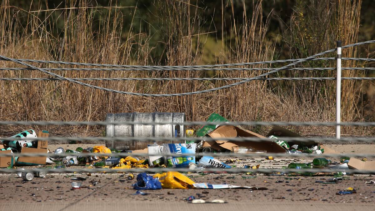 MESS: Kegs and bottles of beer scattered across the road after the accident.