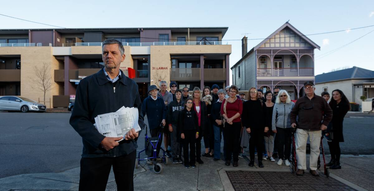 OBJECTION: Glenn Burgess with fellow members of the Cooks Hill Community Group outside the property on Monday. Picture: Max Mason-Hubers