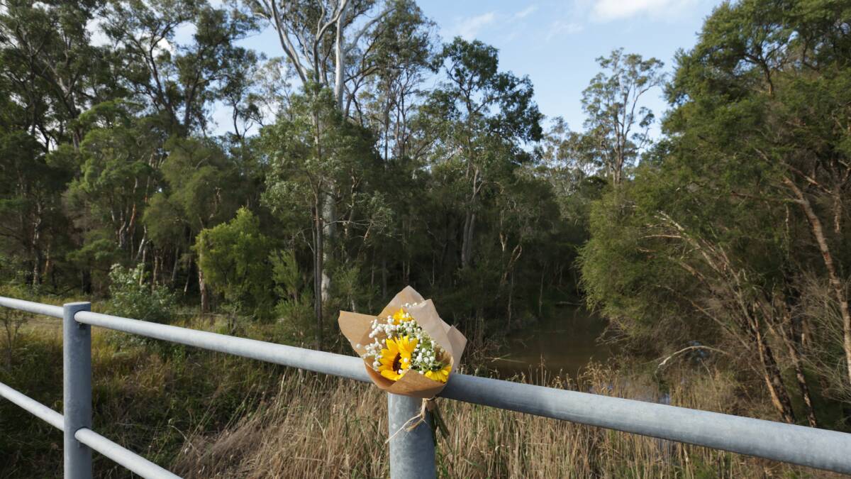 Flowers at Cockle Creek where Ms Easey's body was found. Picture: Simone De Peak