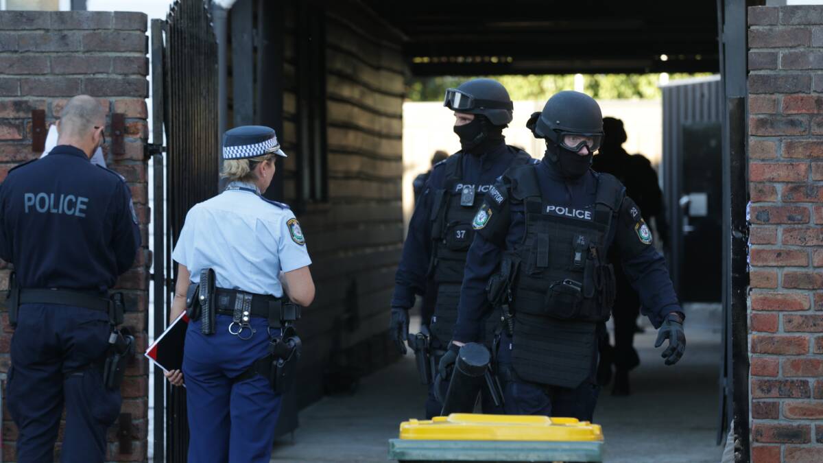'RELENTLESS': Police during a raid on the Nomads in Newcastle in February.