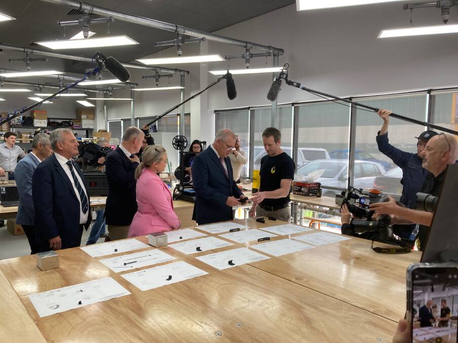 Scott Morrison at Melt in Warners Bay on Wednesday, with University of Newcastle vice chancellor Alex Zelinsky and Liberal candidate for Shortland Nell McGill.