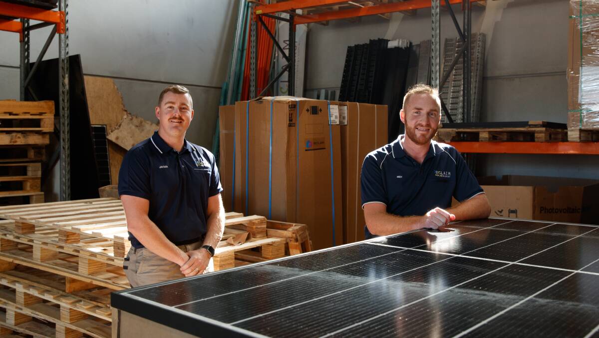Plenty to do: Reclaim Solar Energy managing director Andy Leadbeatter, right, with employee Jayden Austin at the Edgeworth workshop. Picture: Max Mason-Hubers