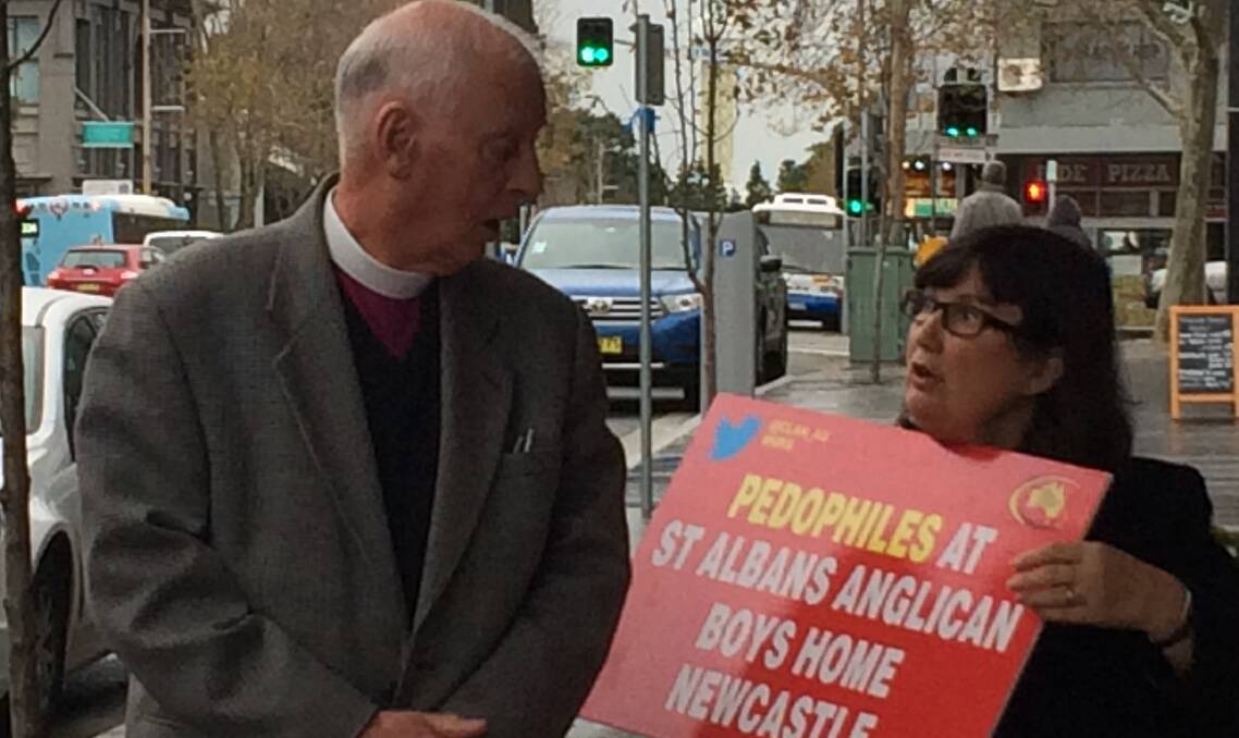 PROTEST: Former Assistant Bishop of Newcastle, Richard Appleby, walks past Leonie Sheedy outside the royal commission on his way to give evidence on Friday morning.