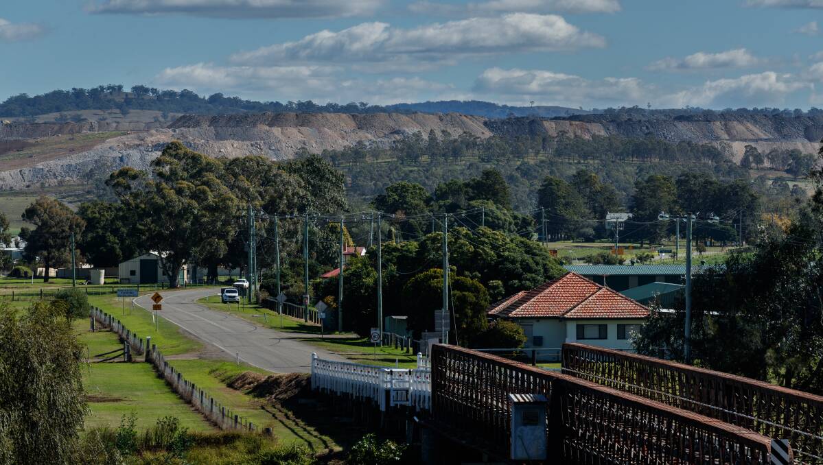 KEY PLAYER: The Mount Pleasant coal mine looms over the streets and houses on the outskirts of Muswellbrook. Pictures: Max Mason-Hubers