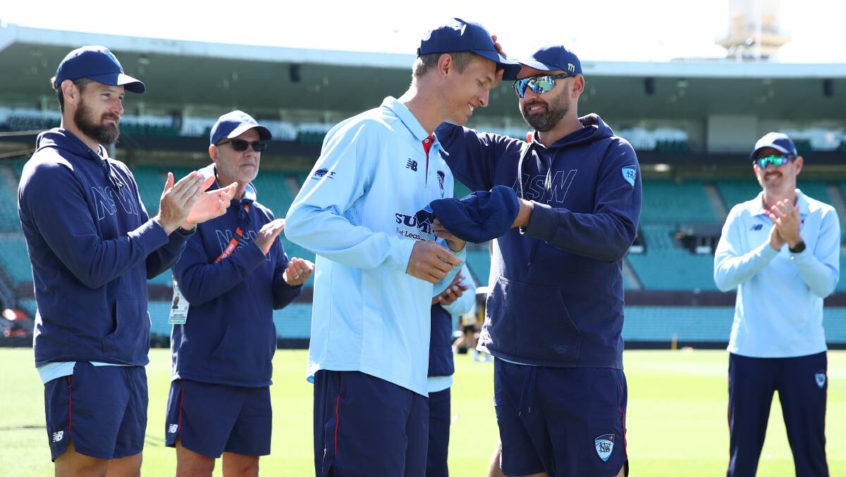 Test great Nathan Lyon presents Toby Gray with his cap. Picture by Getty