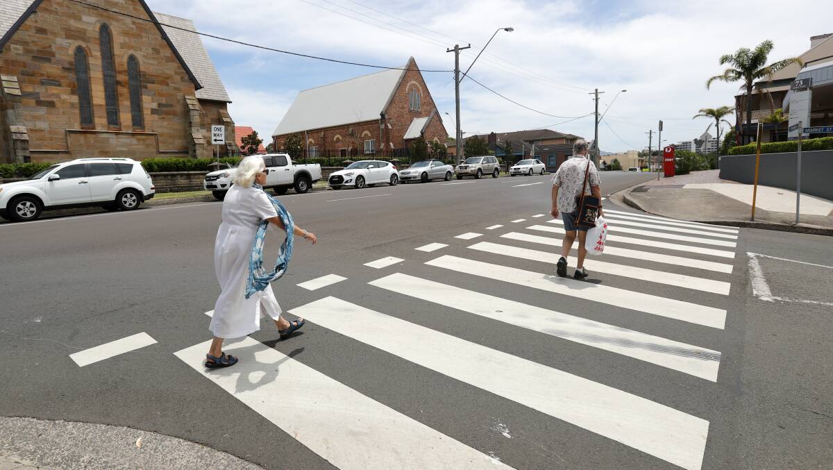 DOING THE RIGHT THING: Pedestrians using a designated crossing.