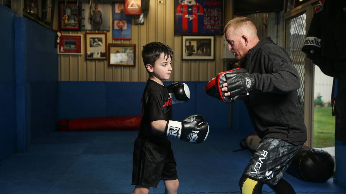FIGHTER: Kane Ransom, eight, during his Brazilian jiu jitsu training with Jamie Ballard. He is undergoing chemotherapy for leukemia. Picture: Marina Neil
