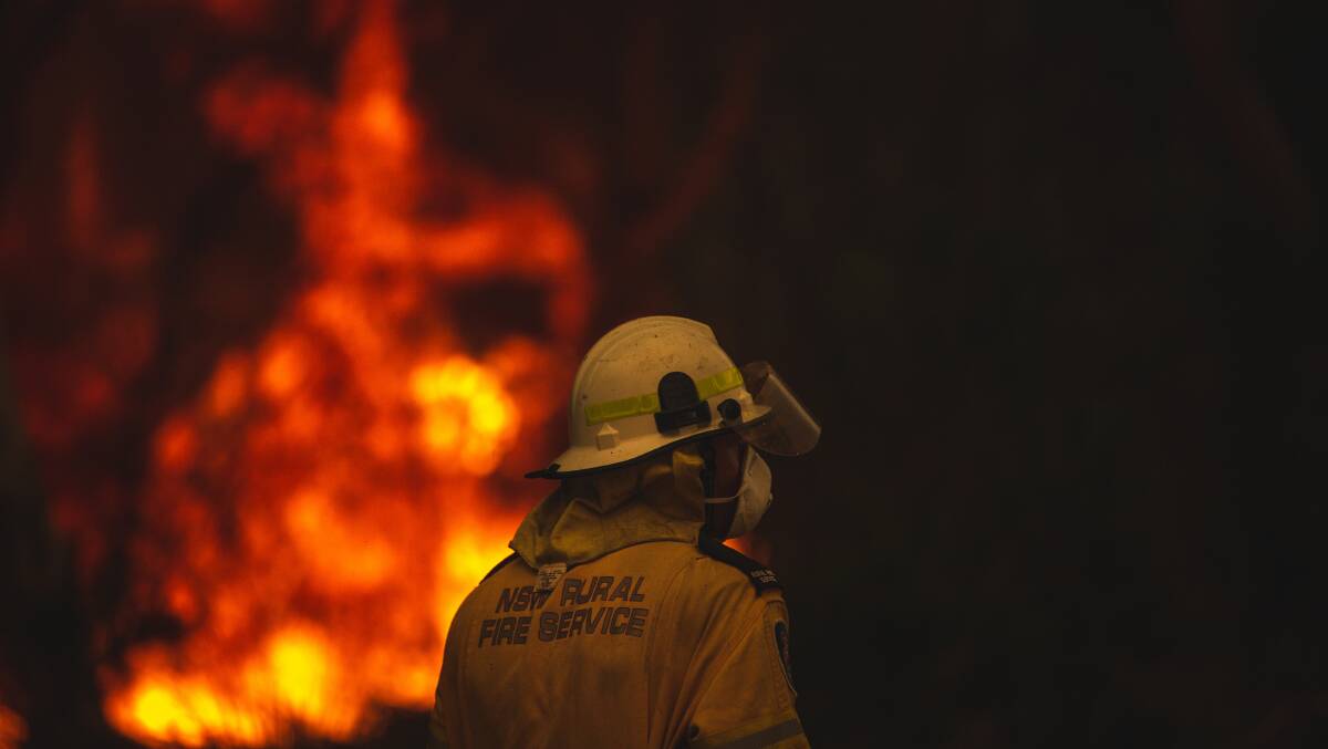 FIRE FIGHT: A Rural Fire Service member at the Charmhaven blaze on New Year's Eve. Picture: Marina Neil