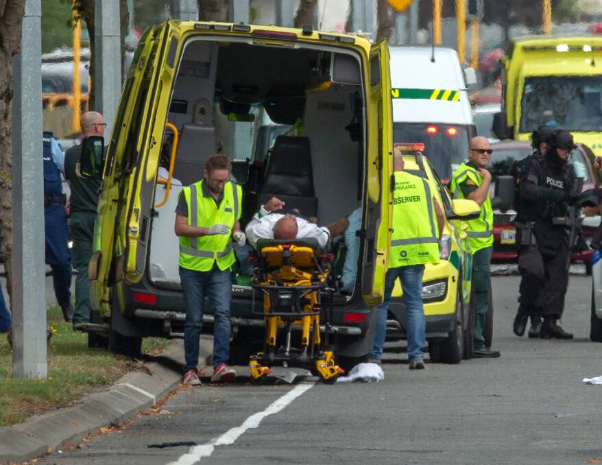 Emergency service workers attend to an injured man in Christchurch.