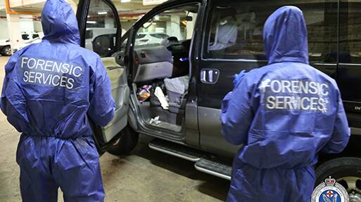 Police examine the Mitsubishi van. Picture: NSW Police