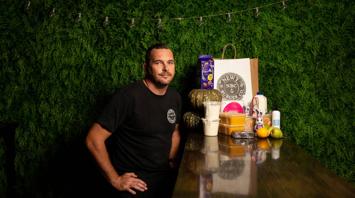 HELPING HAND: Newy Burger Co's Ben Neil with a Kindness Box which includes the free soup packs. Picture Marina Neil