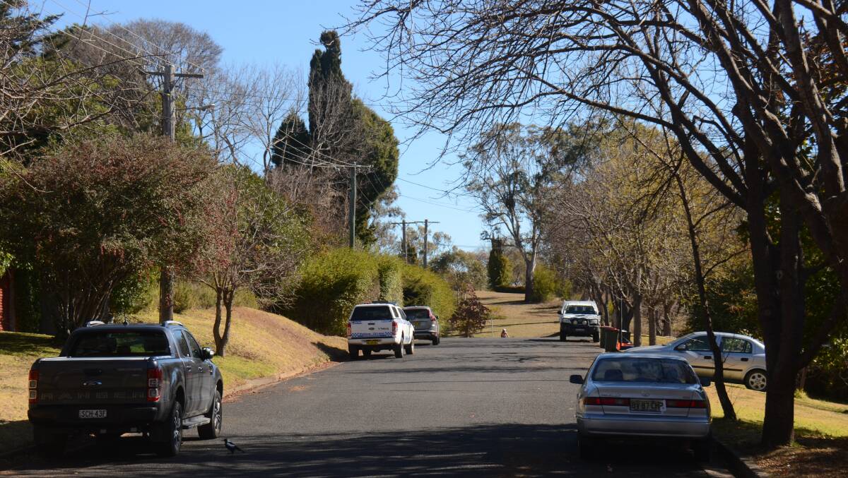 Police guard the crime scene in Girabaldi Street in Armidale on Monday. Picture by Laurie Bullock