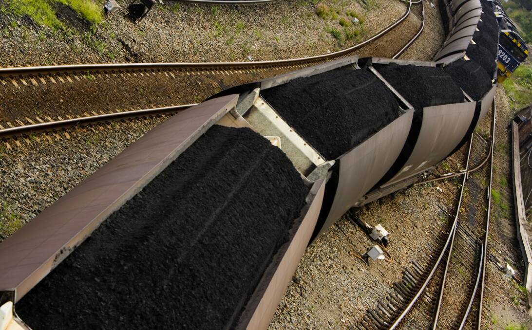 LABOUR INTENSIVE: The Australian Rail Track Corporation found it was not realistic to vacuum up the coal that falls off its wagons as they leave the Port of Newcastle. Picture: Nic Walker 