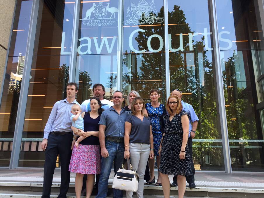 WAGING WAR: Residents of the Williamtown 'red zone' outside the Federal Court of Australia. Gavin and Kim Smith, centre, are the lead applicants in the case against Defence and will allege it failed in its duty of care to residents. 