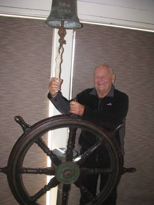 Relics: Reg with a bell and ship’s wheel, which he acquired believing they were from the Adolphe shipwreck at Stockton in 1904. Pictures by Mike Scanlon