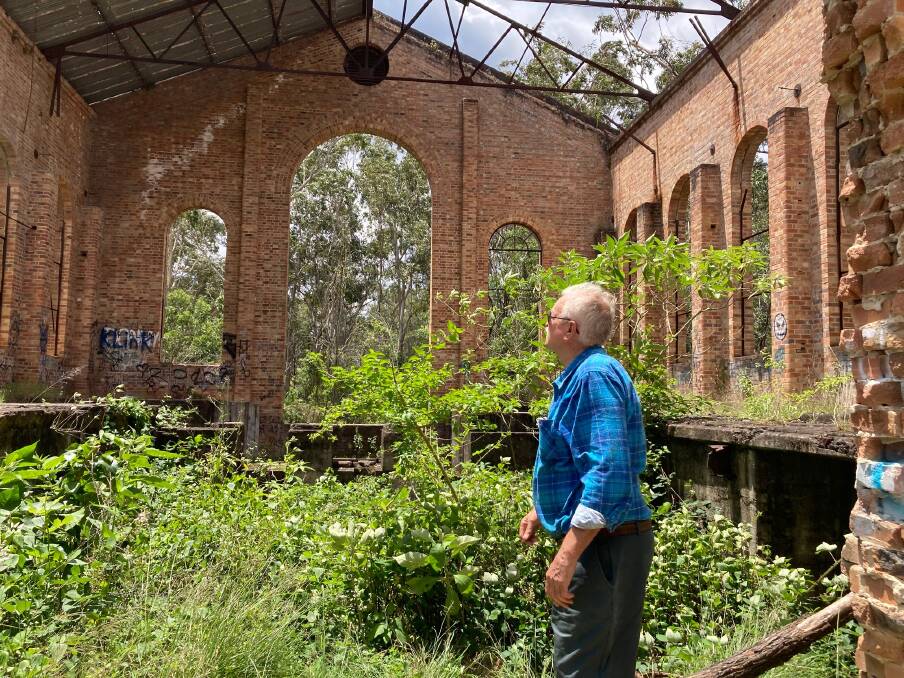 Lost landmark: Kevin Robinson in the overgrown interior of the winding house.