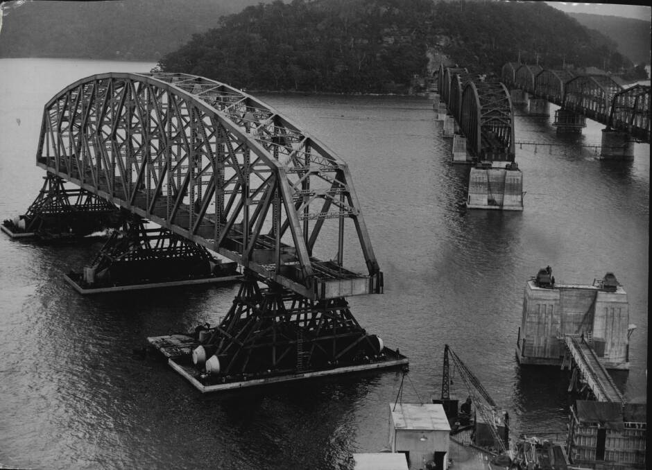 CAREFUL: A span of the Hawkesbury River railway bridge being floated on pontoons into position in 1945. Photo: Fairfax Archive
