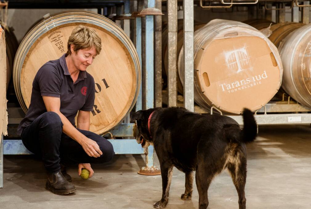 TASTING EDEN: French-born and trained Celine Rousseau, winemaker-manager of Eden Road, in the Murrumbateman winery with her dog Vladdy (AKA Vladimir).